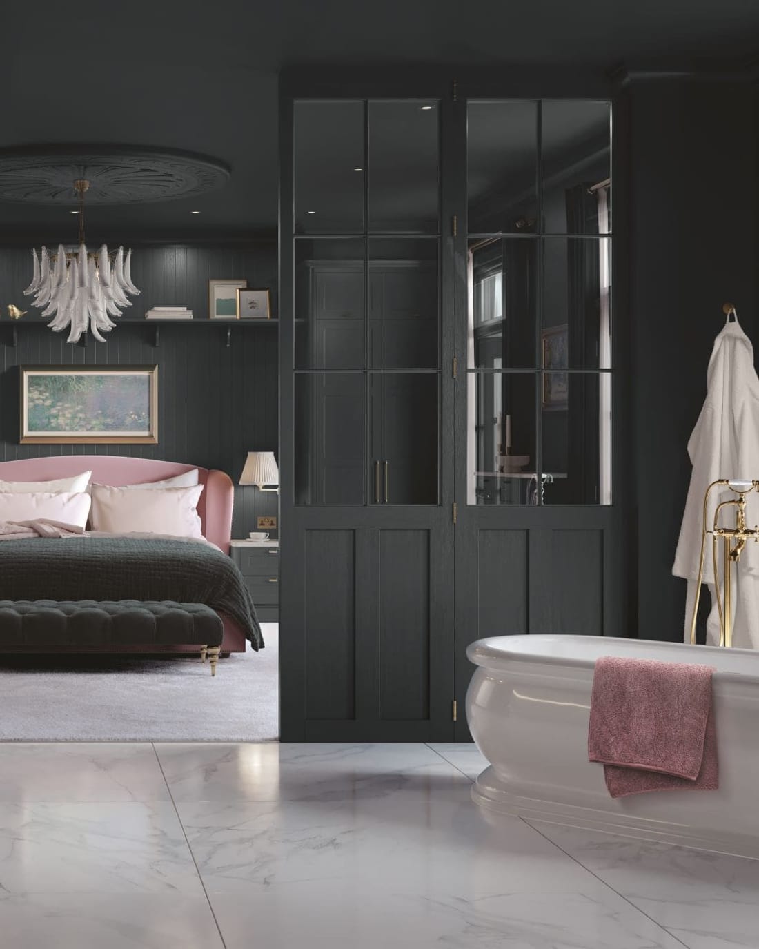 A bedroom fitted floor to ceiling with dark panelled wardrobes, a dark-painted ceiling with a period rose and chandelier, a built-in dressing table, and a pink upholstered bed dressed in blush and green.